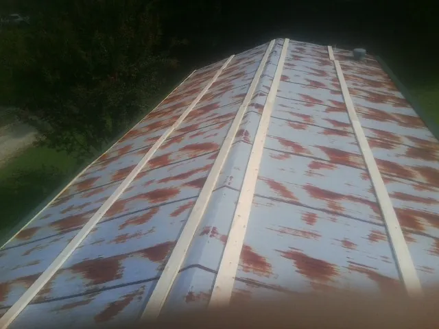 Rusted metal roof panels with new wood purlins before replacement — Storm Damage Roof Repair in Pleasanton by Roofing Brothers